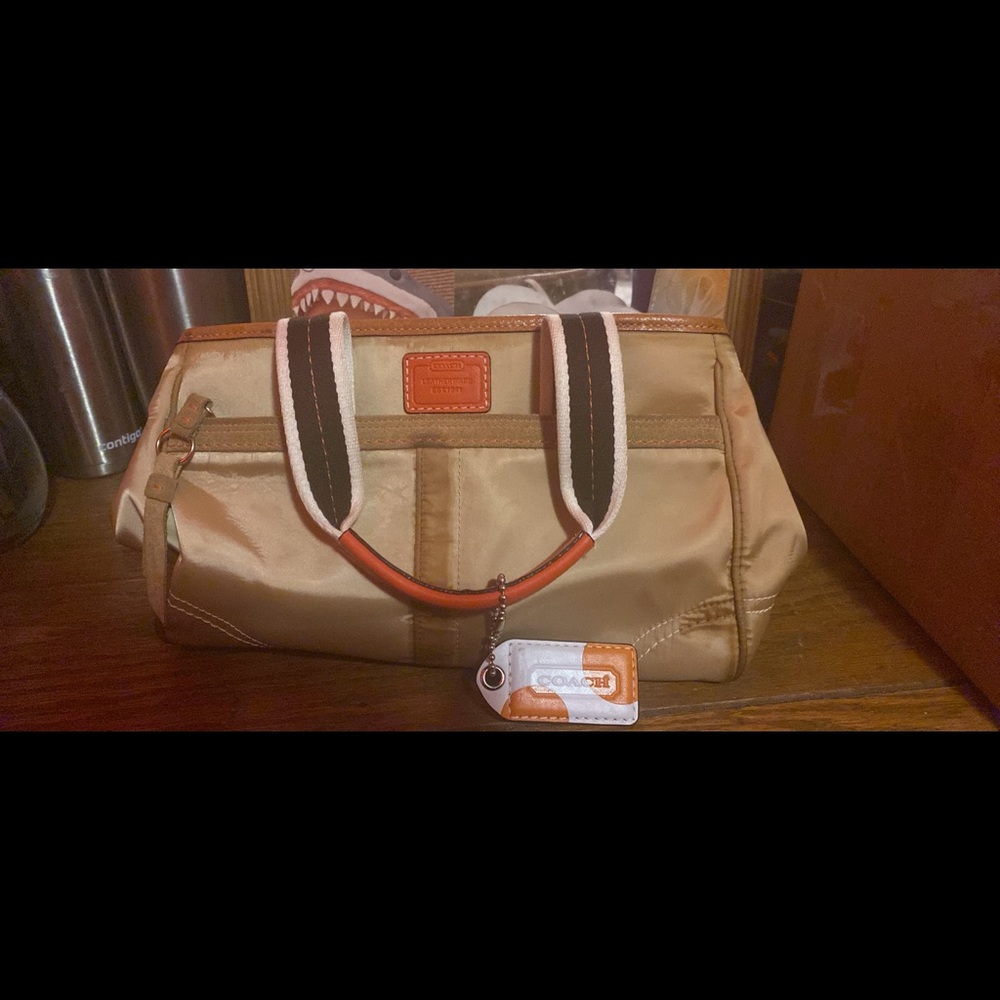 Orange and tan Coach purse